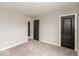 Neutral bedroom featuring gray carpet, light gray walls, and two black doors at 331 Oxford Ln, Lebanon, IN 46052