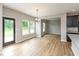 Bright dining area features wood floors, white walls, large windows, and modern light fixture at 331 Oxford Ln, Lebanon, IN 46052