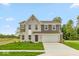 Beautiful two-story home with a brick and vinyl facade, well-manicured lawn, and a two car garage at 331 Oxford Ln, Lebanon, IN 46052