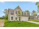 Charming two-story home featuring brick and vinyl siding, a two-car garage, and a well-kept lawn at 331 Oxford Ln, Lebanon, IN 46052