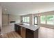 Modern kitchen with granite island and stainless dishwasher, open to the living room and large windows at 331 Oxford Ln, Lebanon, IN 46052