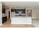 Stylish kitchen with granite counters, dark cabinets, stainless appliances, and an island, open to living space at 331 Oxford Ln, Lebanon, IN 46052