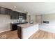 Bright open kitchen featuring a granite island, dark cabinets, stainless steel appliances, and an open floorplan at 331 Oxford Ln, Lebanon, IN 46052