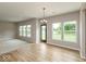 Bright living room with luxury floors, multiple windows, and an open door providing ample natural light at 331 Oxford Ln, Lebanon, IN 46052