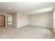 Spacious living room with neutral carpet and paint, leading to other rooms at 331 Oxford Ln, Lebanon, IN 46052