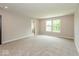 Open living room space, carpeted, with a window and view to the outdoors at 331 Oxford Ln, Lebanon, IN 46052