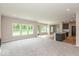 Open-concept layout with plush carpeted living space and wood-floored kitchen area at 331 Oxford Ln, Lebanon, IN 46052