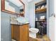 Stylish bathroom with glass bowl sink, wood cabinet, and neutral color scheme at 3400 Debra Dr, Anderson, IN 46012