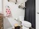 Bathroom features white toilet, unique shelving, and a black shower curtain at 3400 Debra Dr, Anderson, IN 46012