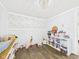 Bright bedroom with wood floors, closet, decorative accents and a large window at 3400 Debra Dr, Anderson, IN 46012