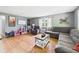 Cozy Gathering room with comfortable furniture, bright windows, and natural wood look floors at 3400 Debra Dr, Anderson, IN 46012
