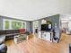 Spacious living room with wood floors, gray walls, large windows, and decorative TV console at 3400 Debra Dr, Anderson, IN 46012