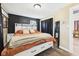 Comfortable main bedroom featuring a large bed, wood-look floors, and dark accent wall at 3400 Debra Dr, Anderson, IN 46012