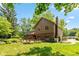 Back exterior view of a two-story home with a brick chimney and a spacious wooden deck at 3479 Sugar Loaf Ct, Carmel, IN 46033