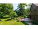 Large wooden deck and manicured backyard with mature trees, firepit area with seating at 3479 Sugar Loaf Ct, Carmel, IN 46033