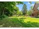 Wide backyard featuring a well-maintained lawn with mature trees providing ample shade and privacy at 3479 Sugar Loaf Ct, Carmel, IN 46033