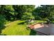 Beautiful backyard featuring a wooden deck with furniture, a well-manicured lawn, and mature trees at 3479 Sugar Loaf Ct, Carmel, IN 46033