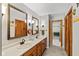 Well-lit bathroom with double sinks, vanity, and stylish mirrors at 3479 Sugar Loaf Ct, Carmel, IN 46033