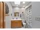 Bright bathroom featuring a single sink vanity, wooden cabinets, and a shower with a charming patterned curtain at 3479 Sugar Loaf Ct, Carmel, IN 46033