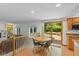 Bright dining area with a round table, deck access, and connecting living space at 3479 Sugar Loaf Ct, Carmel, IN 46033