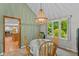 Charming dining room with a beaded chandelier, natural light, and a view of the outdoor greenery at 3479 Sugar Loaf Ct, Carmel, IN 46033