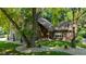 Charming two-story home with brick and wood siding, large tree, and landscaped front yard at 3479 Sugar Loaf Ct, Carmel, IN 46033