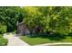 Exterior view of a two-story home with a brick facade, well-kept lawn, and a paved driveway at 3479 Sugar Loaf Ct, Carmel, IN 46033