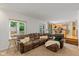 Inviting living room showcasing a comfortable sectional sofa, natural light, and kitchen view at 3479 Sugar Loaf Ct, Carmel, IN 46033
