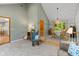 Open-concept living area with vaulted ceilings, carpet flooring, and a dining area in the background at 3479 Sugar Loaf Ct, Carmel, IN 46033