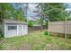 A backyard shed in a fenced yard adds utility and storage at 3898 Chelsea Ter, Greenwood, IN 46143