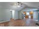 Open concept living room and kitchen with hardwood floors, bright lighting, and modern appliances at 3898 Chelsea Ter, Greenwood, IN 46143