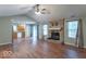 Spacious living room featuring a brick fireplace, hardwood floors, and an open layout to the kitchen at 3898 Chelsea Ter, Greenwood, IN 46143
