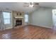 Cozy living room featuring a brick fireplace, hardwood floors, and bright natural light at 3898 Chelsea Ter, Greenwood, IN 46143