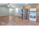 Open-concept living space with wood flooring and modern appliances at 3898 Chelsea Ter, Greenwood, IN 46143