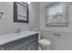 Updated bathroom with white sink, blue vanity, and bright natural light at 454 E Broadway St, Greenwood, IN 46143