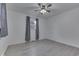 Bright bedroom with a ceiling fan and window dressed with elegant patterned curtains at 454 E Broadway St, Greenwood, IN 46143