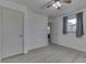 Spacious bedroom featuring sleek flooring, a window, and a unique whitewashed brick accent wall at 454 E Broadway St, Greenwood, IN 46143