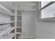 Organized walk-in closet with built-in shelving and natural light at 454 E Broadway St, Greenwood, IN 46143