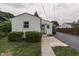 Charming single-story home with white siding, a well-manicured lawn, and a paved walkway to the front entrance at 454 E Broadway St, Greenwood, IN 46143
