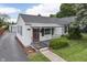 Charming home featuring a well-maintained yard and a welcoming red door at 454 E Broadway St, Greenwood, IN 46143