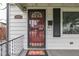 Inviting entryway with a decorative red door and a charming 'Welcome' mat at 454 E Broadway St, Greenwood, IN 46143