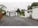 Exterior view of a detached garage with a paved driveway, complementing the main house at 454 E Broadway St, Greenwood, IN 46143