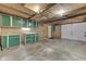 Well-organized garage interior featuring built-in green cabinets, plywood walls, and a practical storage space at 454 E Broadway St, Greenwood, IN 46143