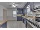 Classic kitchen featuring stylish navy cabinets, stainless steel appliances, and bright, clean flooring at 454 E Broadway St, Greenwood, IN 46143