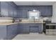Kitchen featuring wood-look counters, blue cabinets, and stainless steel appliances at 454 E Broadway St, Greenwood, IN 46143