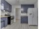 Spacious kitchen with blue cabinets, stainless steel appliances, and ample counter space at 454 E Broadway St, Greenwood, IN 46143