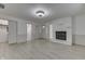 Open-concept living room with fireplace, light wood-look floors, and easy access to other rooms at 454 E Broadway St, Greenwood, IN 46143