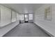 Enclosed sunroom featuring multiple windows for ample natural light and neutral carpeting at 454 E Broadway St, Greenwood, IN 46143