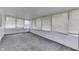 Bright and airy sunroom featuring many large windows, white walls, and neutral carpeting at 454 E Broadway St, Greenwood, IN 46143