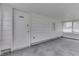 Cozy sunroom with white paneling, an office door, multiple windows, and neutral carpeting at 454 E Broadway St, Greenwood, IN 46143